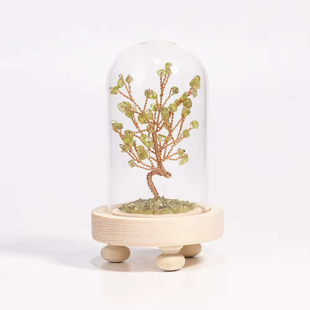 Crystal tree in a glass dome with wooden base, crafted with olivine