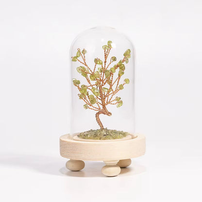 Crystal tree in a glass dome with wooden base, crafted with olivine