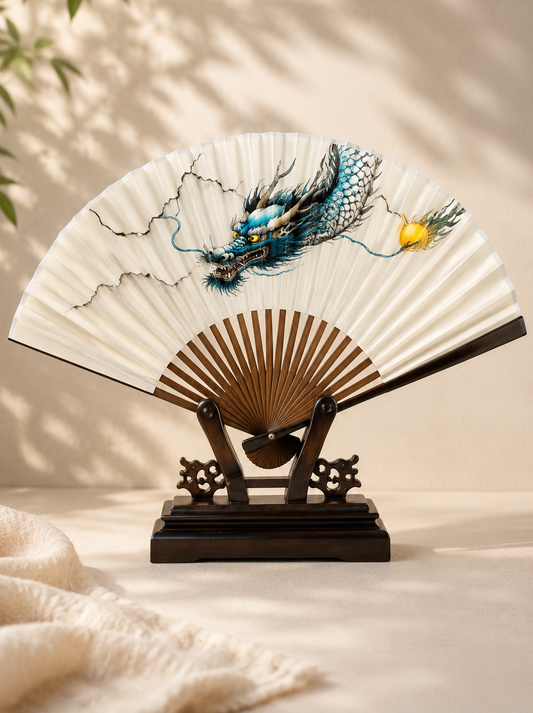 Decorative folding fan with dragon design on a wooden stand 