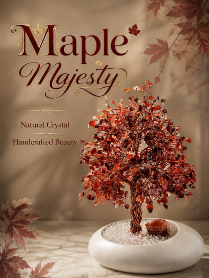 A decorative crystal tree sculpture with reddish-brown maple leaf-shaped crystals  displayed in a white oval planter filled with white stones. 